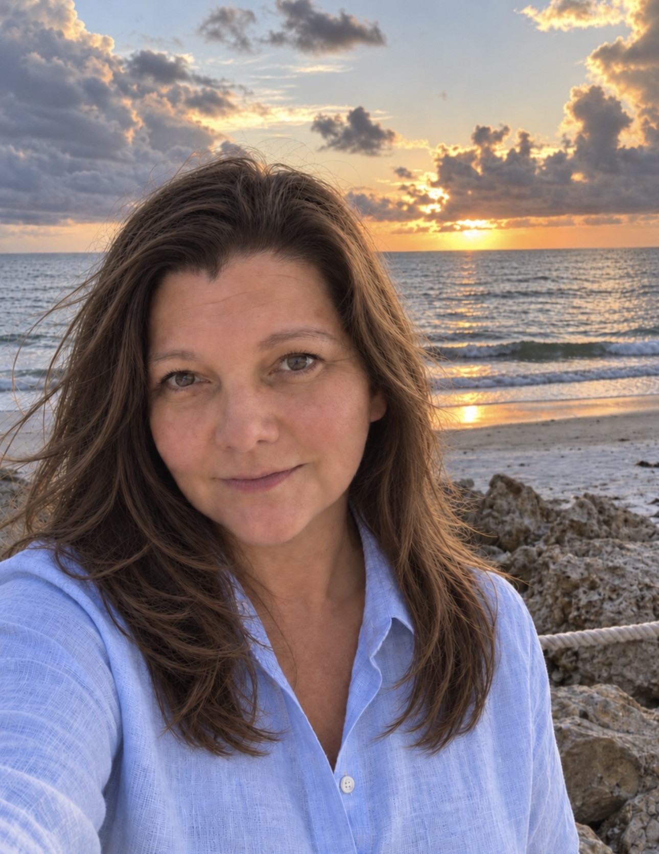Christy Armstrong beside the Gulf at sunset